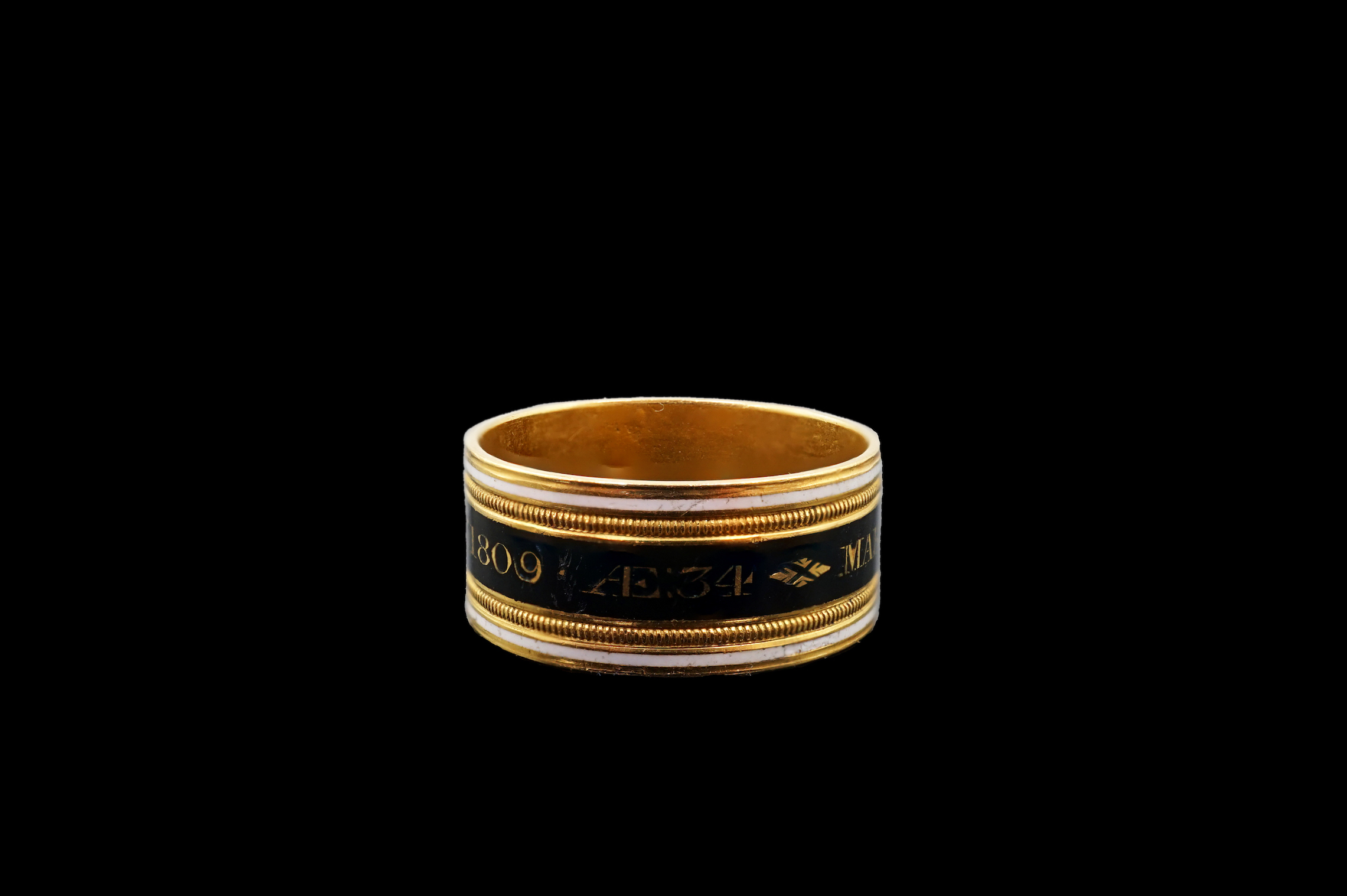 A George III 22ct gold and two colour enamel mourning band, inscribed 'Mary Powell OB. 12 Mar, 1809'